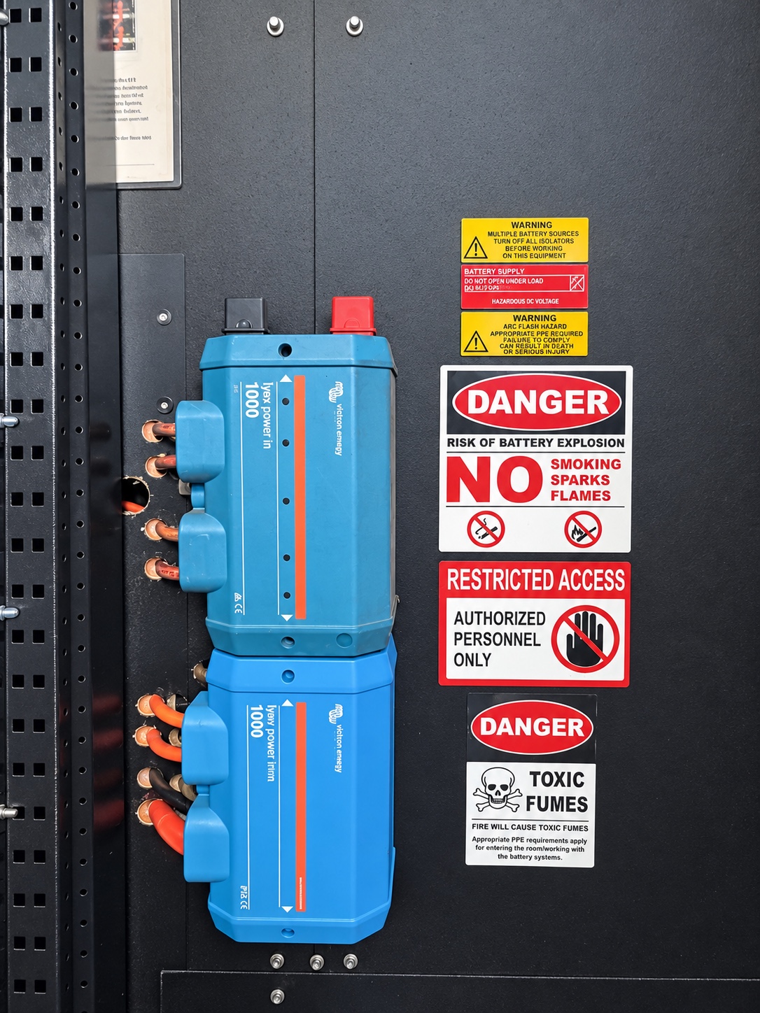 Blue Victron Lynx distribution equipment and safety signage in the power shed